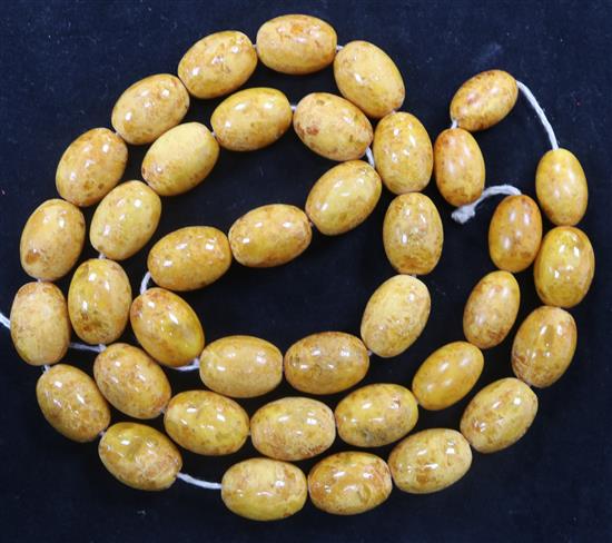 A single strand amber bead necklace, 76cm.